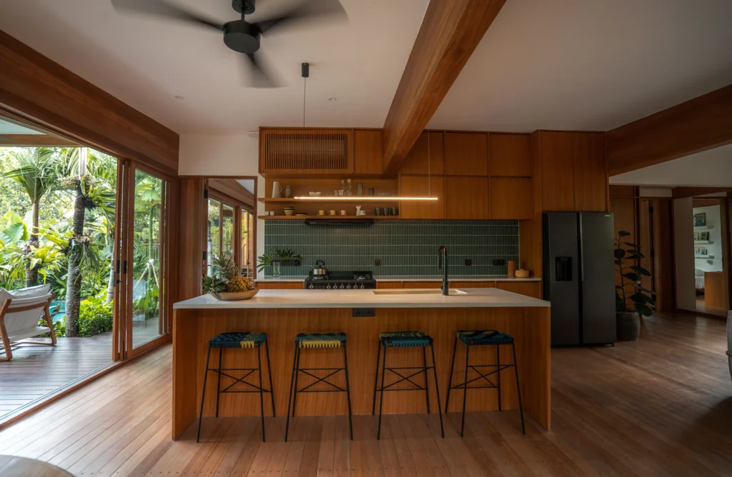 kitchen interior of bawa house connected with living room and outdoor swimming pool area