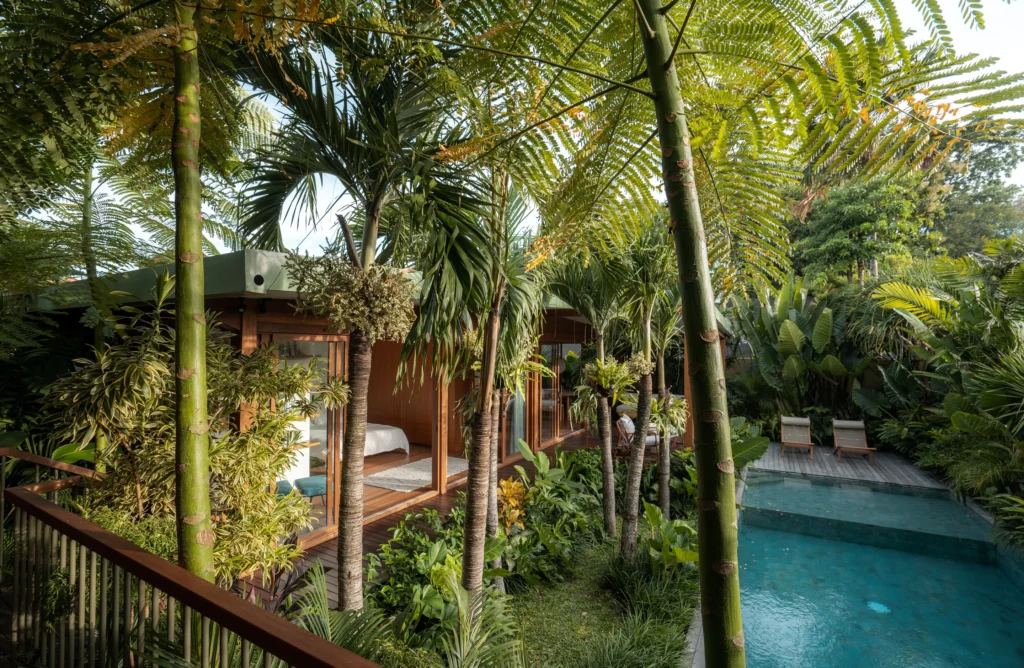 Bawa House by Stilt Studios with main building, swimming pool and guest building nestled with green tree